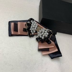 Pink and black brooch